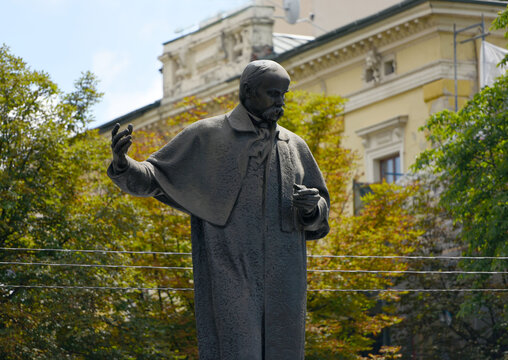LVIV, UKRAINE - JULY 27, 2020: statue of Taras Shevchenko- famous ukrainian poet, artist,  with a 12-meter decorative stele with reliefs located on prospect Svobody in Lviv