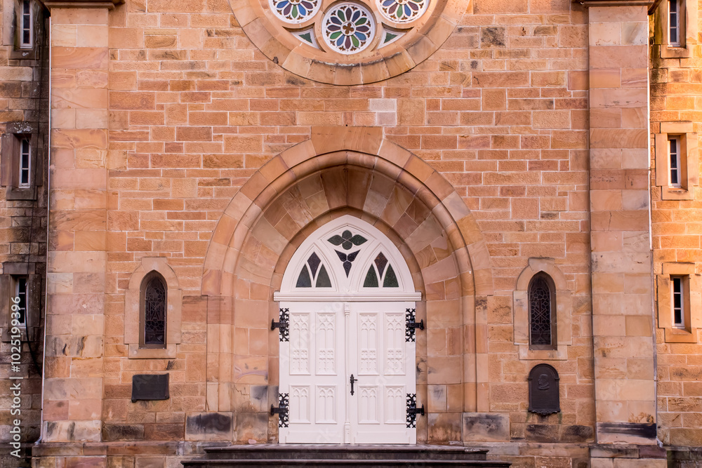 Wall mural Details of ancient stone church, big door