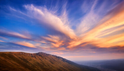 Stunning sunset over rolling hills with dramatic clouds showcasing vibrant colors in the evening sky