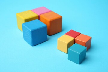 Many colorful cubes on light blue background