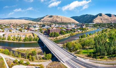 Aerial panorama of Missoula, Montana, above Beartracks Bridge. Missoula is a city in and the county seat of Missoula County, Montana. It is located along the Clark Fork River.