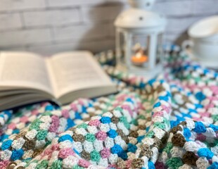 Cozy autumn or winter photo with crochet blanket, flashlight and blue headphones	

