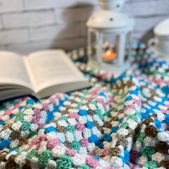 Cozy autumn or winter photo with crochet blanket, flashlight and blue headphones	
