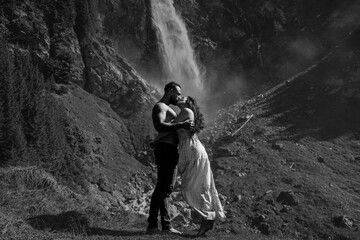 Sensual couple embraced passionately on the nature. Couple kiss on nature. The romantic couple in love on summer nature. Outdoor portrait of sexy sensual couple. Tender kiss and passionate touching.