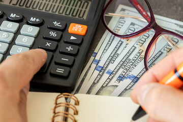 Financial settlements in US dollars, Financial analysis, Tax calculation, Risk costs, business project. United States money, close up.