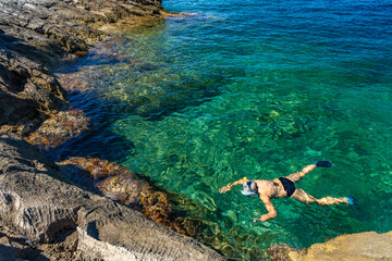 A shapely girl swims in the Adriatic Sea off the coast of Croatia