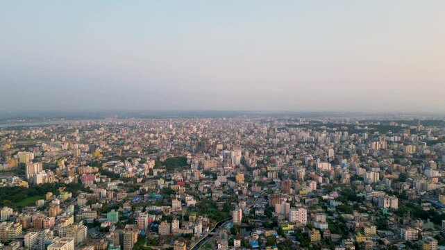 Aerial view of the densely populated and unplanned cityscape of Chittagong, Bangladesh. The city is packed with buildings of various sizes, crisscrossed by narrow streets