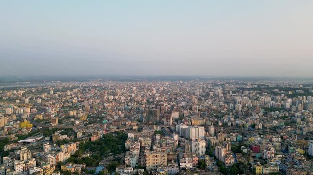 Aerial view of the densely populated and unplanned cityscape of Chittagong, Bangladesh. The city is packed with buildings of various sizes, crisscrossed by narrow streets