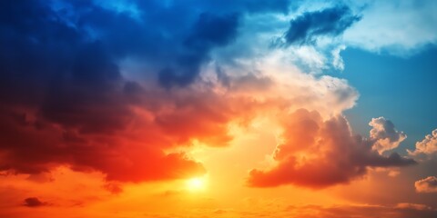 Fototapeta premium A colorful sky with a sun in the middle. The sky is filled with clouds and the sun is shining brightly