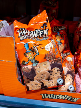 Italy - October 11, 2024: Halloween biscuits with milk and chocolate in the shape of bat and pumpkin in package for sale in supermarket on Halloween days