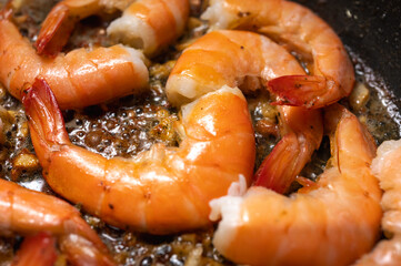 fried red shrimp in a pan, cooking fish dishes, fish food, selective focus, background
