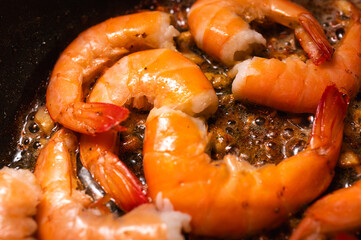 fried red shrimp in a pan, cooking fish dishes, fish food, selective focus, background