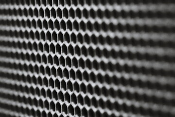 A close-up shot of a grill grate in black and white.