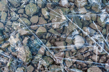 Full frame of frozen water surface in a river in the form of ice Abstract ice background. Blue background with cracks on the ice surface