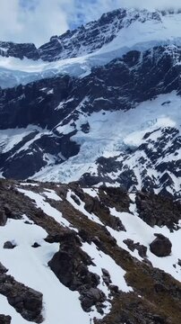Snowy Landscape with Rocky Peaks and Frozen Hills