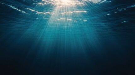 Fototapeta premium Underwater scene with sunbeams shining through the water.