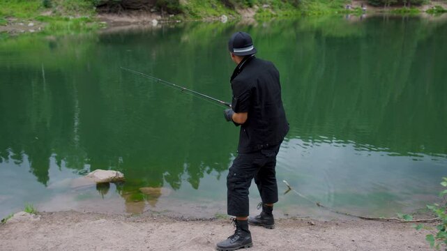 Man casting out line into water then frantically reeling in