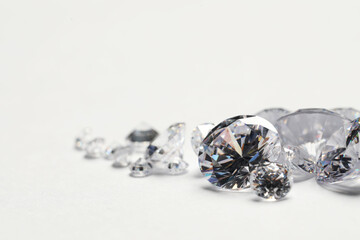 Many beautiful shiny diamonds on white background, closeup. Space for text