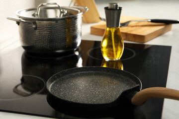 Frying pan with oil on cooktop in kitchen, closeup
