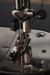 Sewing machine on grey background, closeup view
