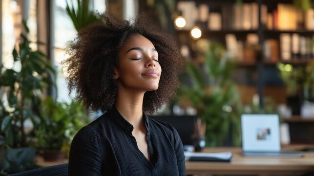 A Woman with Curly Hair Relaxing in a Modern Office
