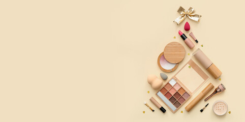 Christmas tree made of makeup products and decorations on beige background