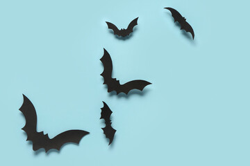 Paper bats for Halloween party on blue background