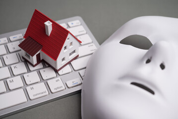 House, keyboard computer, white mask scammer on gray background. Real estate, property, land,...