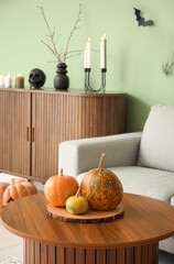Halloween pumpkins on table in living room, closeup