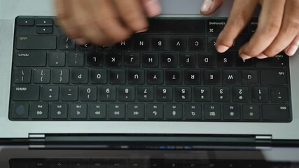 Flat lay of male hand typing on the laptop computer. Closeup.