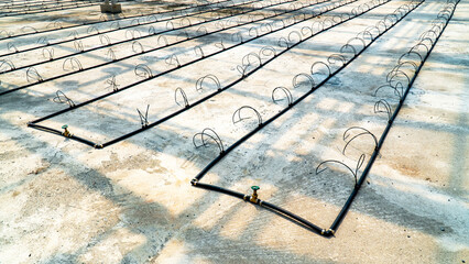 Water pipe irrigation system valve with dripper spike head in greenhouse. Water pipes valve connect in nursery plant with dripper spike drip.