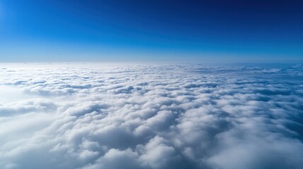 A breathtaking aerial view of a vast expanse of fluffy white clouds against a clear, azure blue sky, offering a sense of tranquility and endless possibilities.