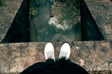 person standing on the end of the water channel