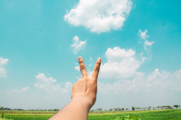 hands reaching out to the sky in peace gesture