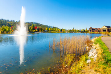 Fototapeta premium The picturesque Riverstone park and mixed use development along the Spokane River at Autumn, in downtown Coeur d'Alene, Idaho, in the North Idaho panhandle region.