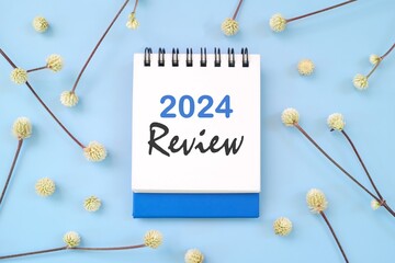 2024 year in review concept. Note typography in blue background flat lay.