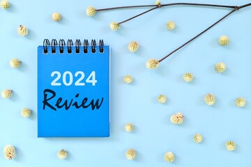 2024 year in review concept. Note typography in blue background flat lay.