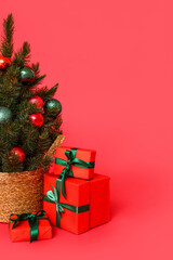 Small Christmas tree with gifts on red background
