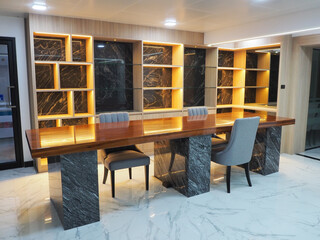 Interior of a modern conference room with glass and marble walls.