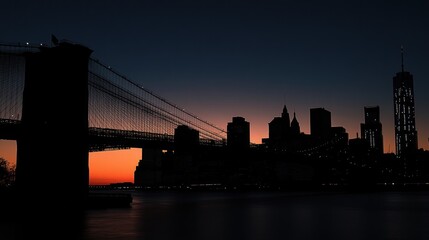 Fototapeta premium A silhouette of the Brooklyn Bridge and the New York City skyline at sunrise.