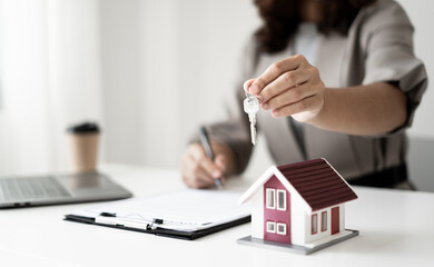 agents working in real estate investment and home insurance signing contracts in accordance with the home buying insurance agreements approving purchases for clients