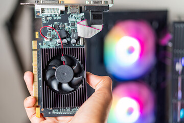Hand Holding a Graphics Card with RGB Background