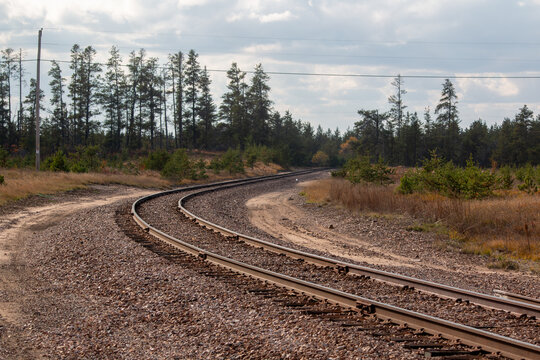 railroad tracks and crossing power lines in the countryside