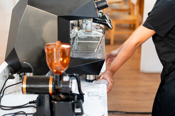Barista Operating Espresso Machine in Café