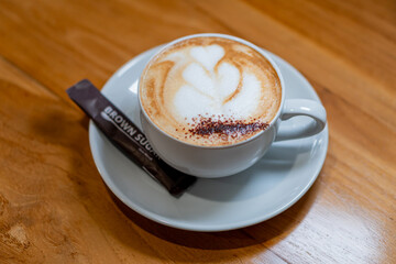 Cappuccino with Heart Latte Art on Wooden Table