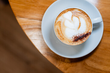 Cappuccino with Latte Art on Wooden Table
