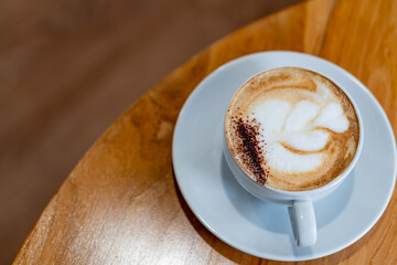 Cappuccino with Latte Art on Wooden Table