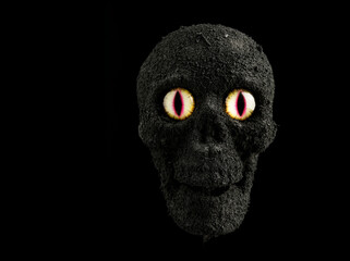 Homemade scary skull with menacing eyes still life handmade by Photographer