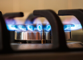 Gas burners lit in modern kitchen