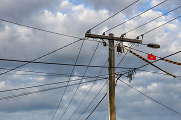 electricity pole and lines against sky